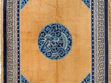 a blue and yellow rug with a medallion design on it