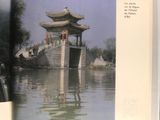 an open book with a picture of a pagoda in the water