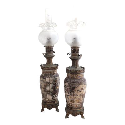 pair of asian vases with lamps on stands on a white background