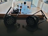 two lights that are sitting on a table in a room