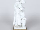 statue of a woman holding a child in her arms on a marble base