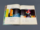 an open book with a picture of a vase of flowers on it