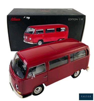 a red toy bus that is in front of a box