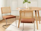 a table with two chairs and a vase on top of it
