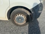 a white van that has a flat tire on it