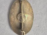 an image of a brass button with a hook on it