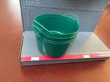 a green bucket sitting on top of a shelf in a store
