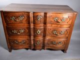 a wooden chest of drawers with brass handles on it