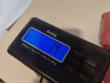 a digital scale sitting on top of a table next to a pair of scissors