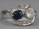 an image of a close up of a ring with a sapphire and a diamond