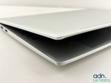 a close up of a laptop on a white surface