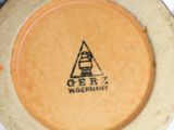 a yellow plate with a black and white logo on it