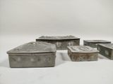several pieces of silverware sitting on top of a white surface