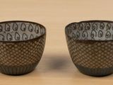 two cups that are sitting on a table