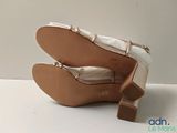 pair of women ' s shoes on a white surface with a white background