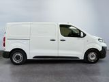the white van is parked in a room with a gray floor