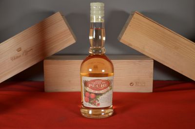 a bottle of liquor sitting on a table next to a wooden box
