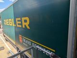 a green and yellow truck that is parked on the side of the road