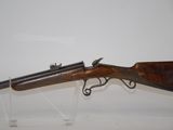 a rifle that is on display in a glass case