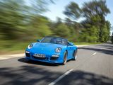 the blue sports car is driving down the road in motion