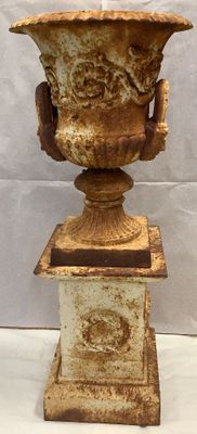 a vase that is sitting on a pedestal on a table
