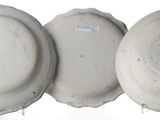 three white plates with blue designs on them