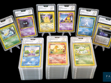 a lot of pokemon cards that are in a pile