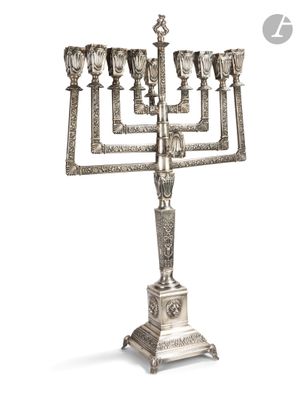 a large silver menorah with five candles on a stand
