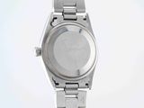 a close up of a watch on a metal bracelet on a white surface