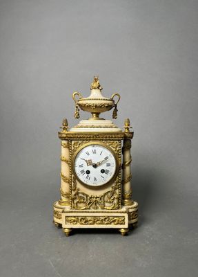 a gold clock that is sitting on a table