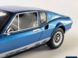 a blue toy car that is sitting on a white surface