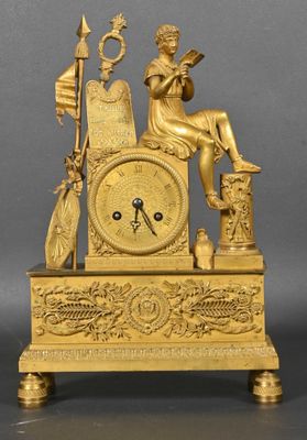 an image of a gold clock sitting on top of a table