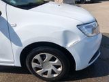 a white car parked in a parking lot with other cars in the background