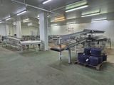 a large room with a conveyor belt in it