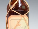 an image of a bottle of whiskey tied to a string