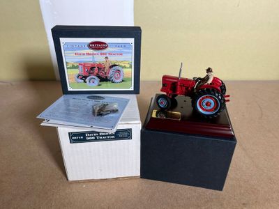 a toy tractor sitting next to a box on a table