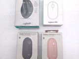 three boxes of computer mouses sitting on top of a white surface
