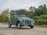 a green car that is parked on the side of the road