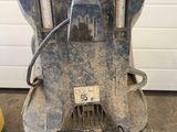 a dirty machine that is sitting in the garage