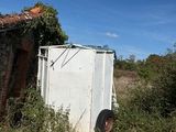 a white refrigerator sitting in the middle of a field
