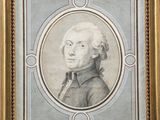 portrait of a man in a suit and tie in a gold frame