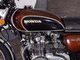 a brown and black motorcycle parked next to a white wall