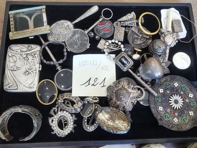 a black box filled with assorted silver items on a table
