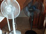 two fans sitting on the floor next to each other