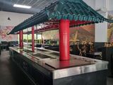 an image of a restaurant with a long counter and red pillars