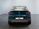 the rear end of a blue car in a white room