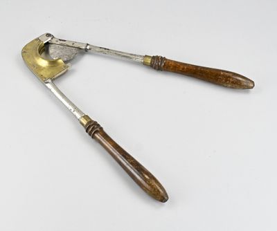 a close up of a pair of tonges on a white surface