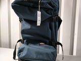 a blue backpack sitting on a table with a tag on it