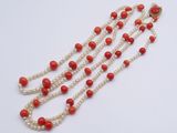 a close up of a red and white beaded necklace