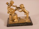 brass figurine of two cherensils on a marble base